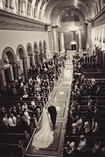 Bride and groom walking down church aisle