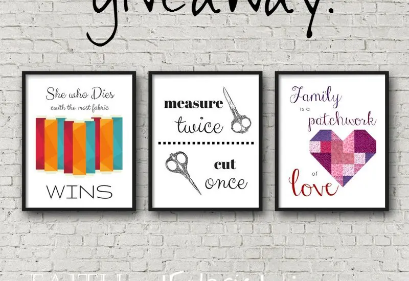 Three framed quilting prints on brick wall