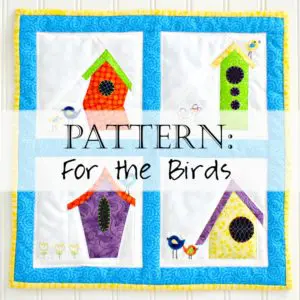 Quilted wall hanging with four birdhouses