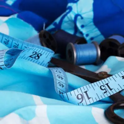 Blue fabric with measuring tape and scissors