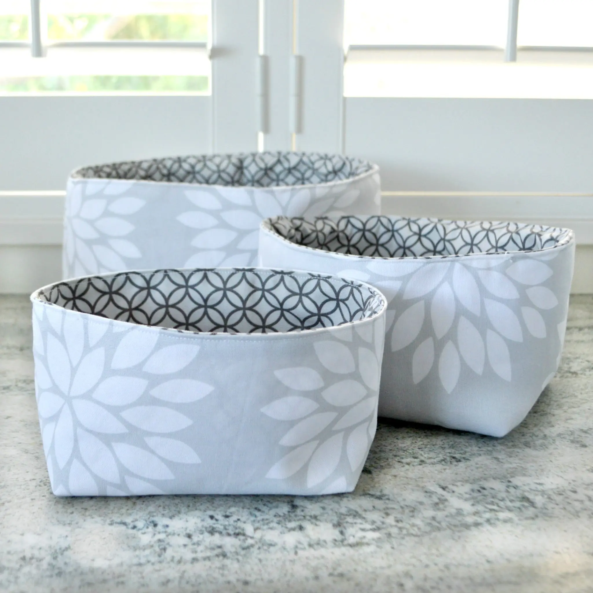 Set of three gray patterned fabric baskets