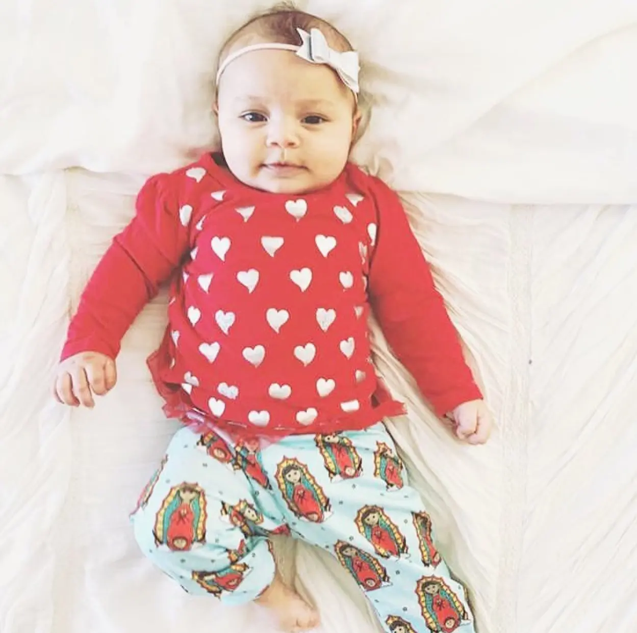 Baby wearing red heart shirt and headband