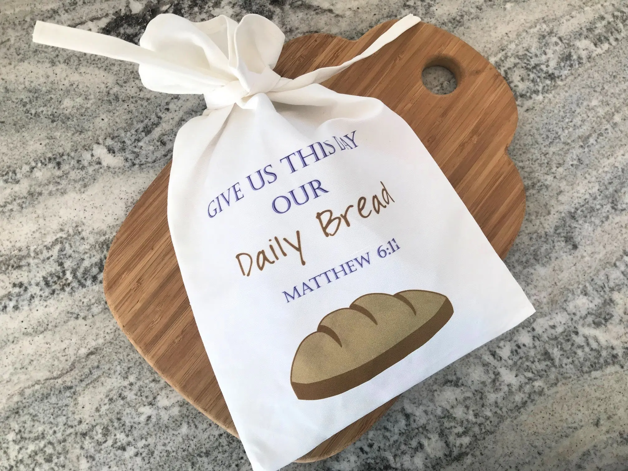 Cloth bread bag on wooden cutting board